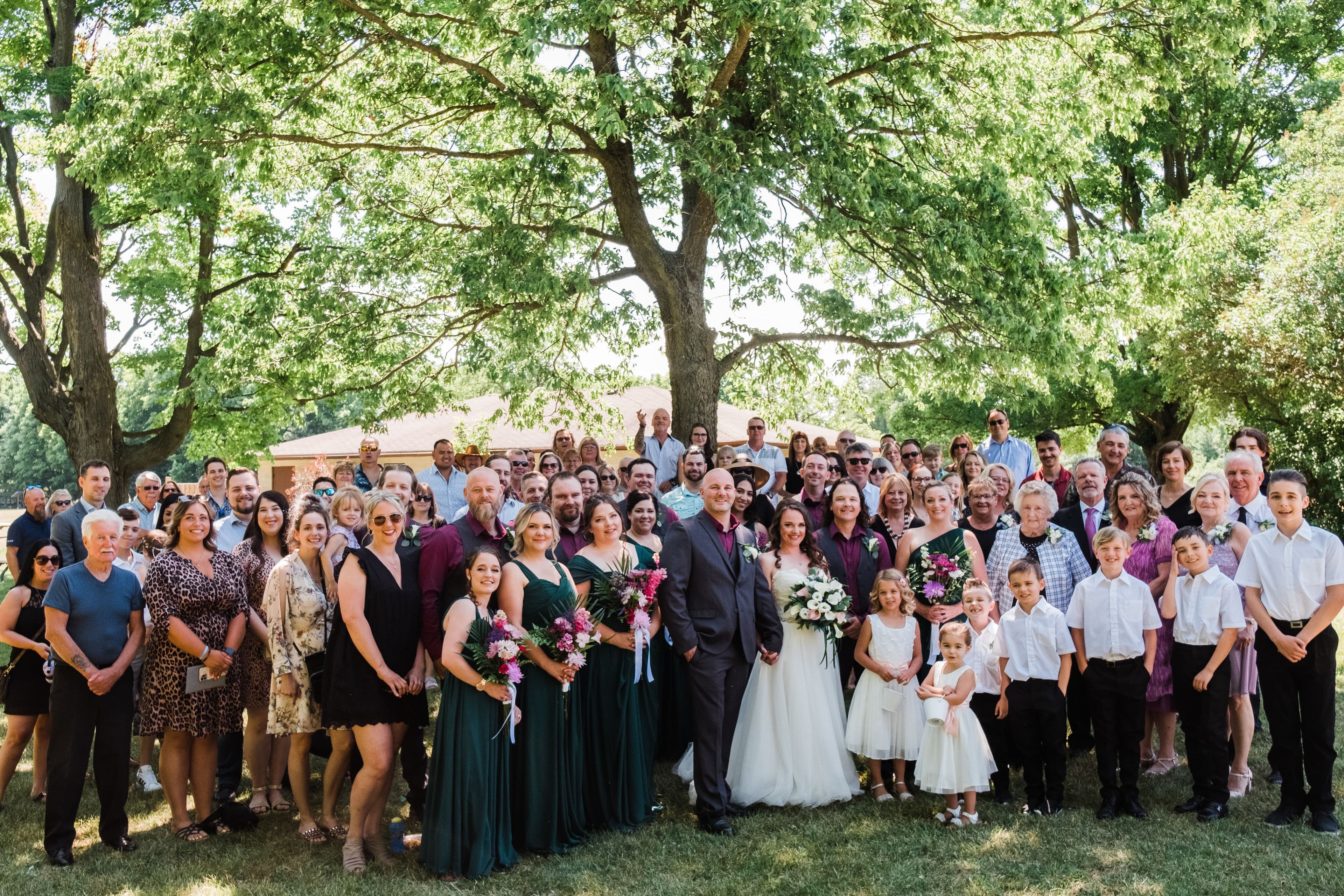 The wedding ring, Waterloo Regional Police Association, BMKH Photography, KW wedding photographer, Waterloo wedding venue, Kitchener wedding venue, Cambridge wedding venue, bride and groom and all their guests standing for a group photo