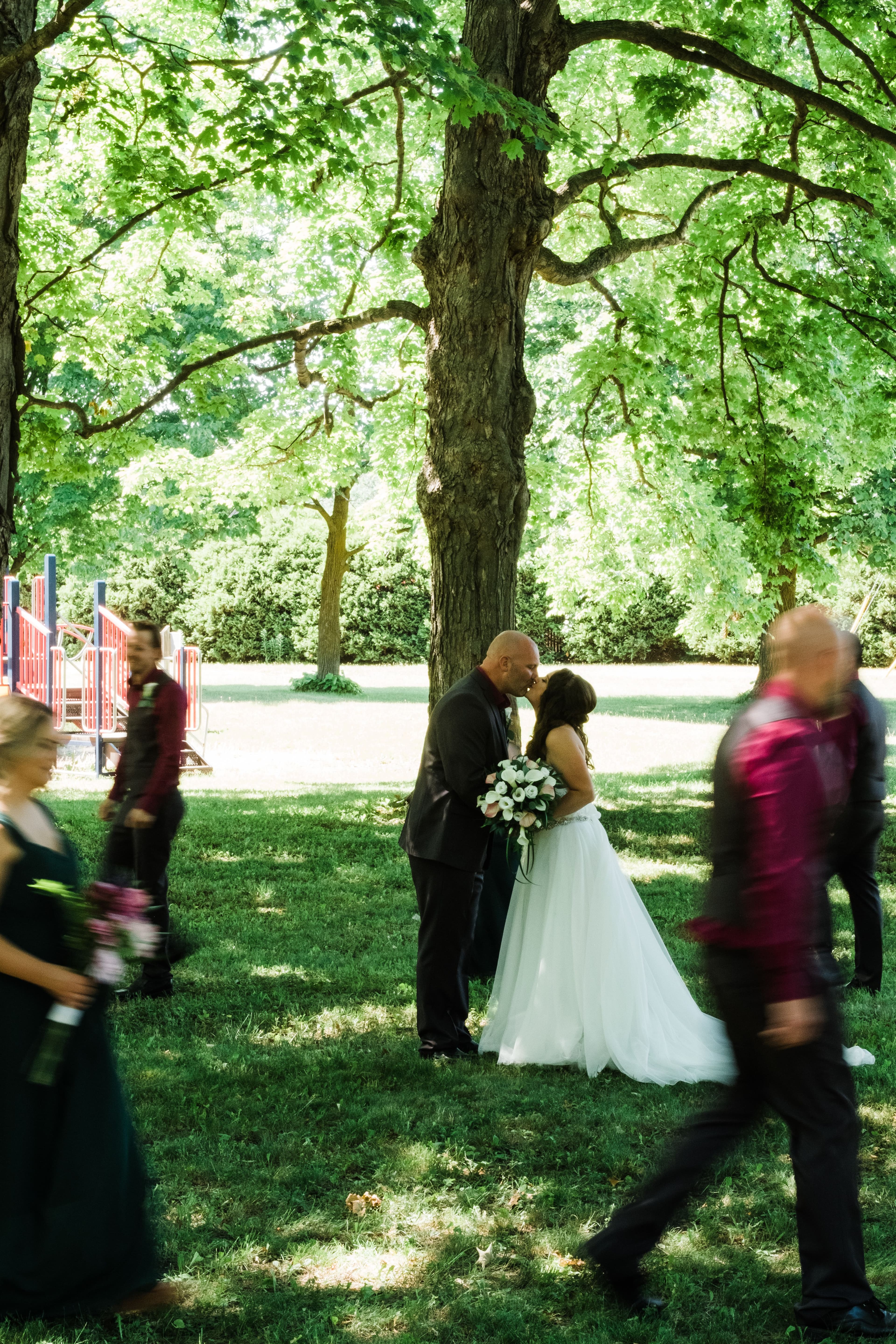 The wedding ring, Waterloo Regional Police Association, BMKH Photography, KW wedding photographer, Waterloo wedding venue, Kitchener wedding venue, Cambridge wedding venue, bride and groom kissing while their wedding party stands around them