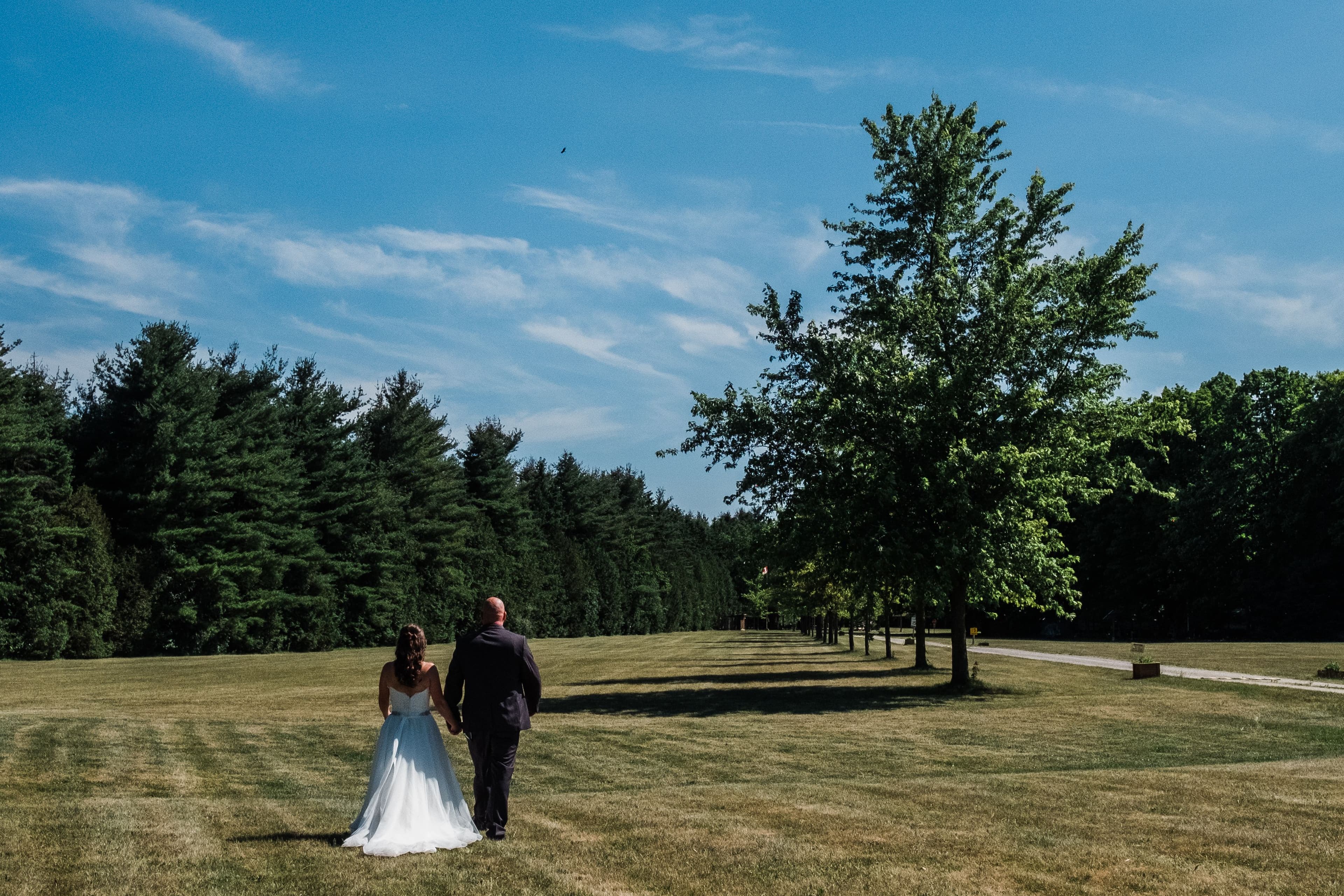 The wedding ring, Waterloo Regional Police Association, BMKH Photography, KW wedding photographer, Waterloo wedding venue, Kitchener wedding venue, Cambridge wedding venue, wedding decor, bride and groom walking away into a field