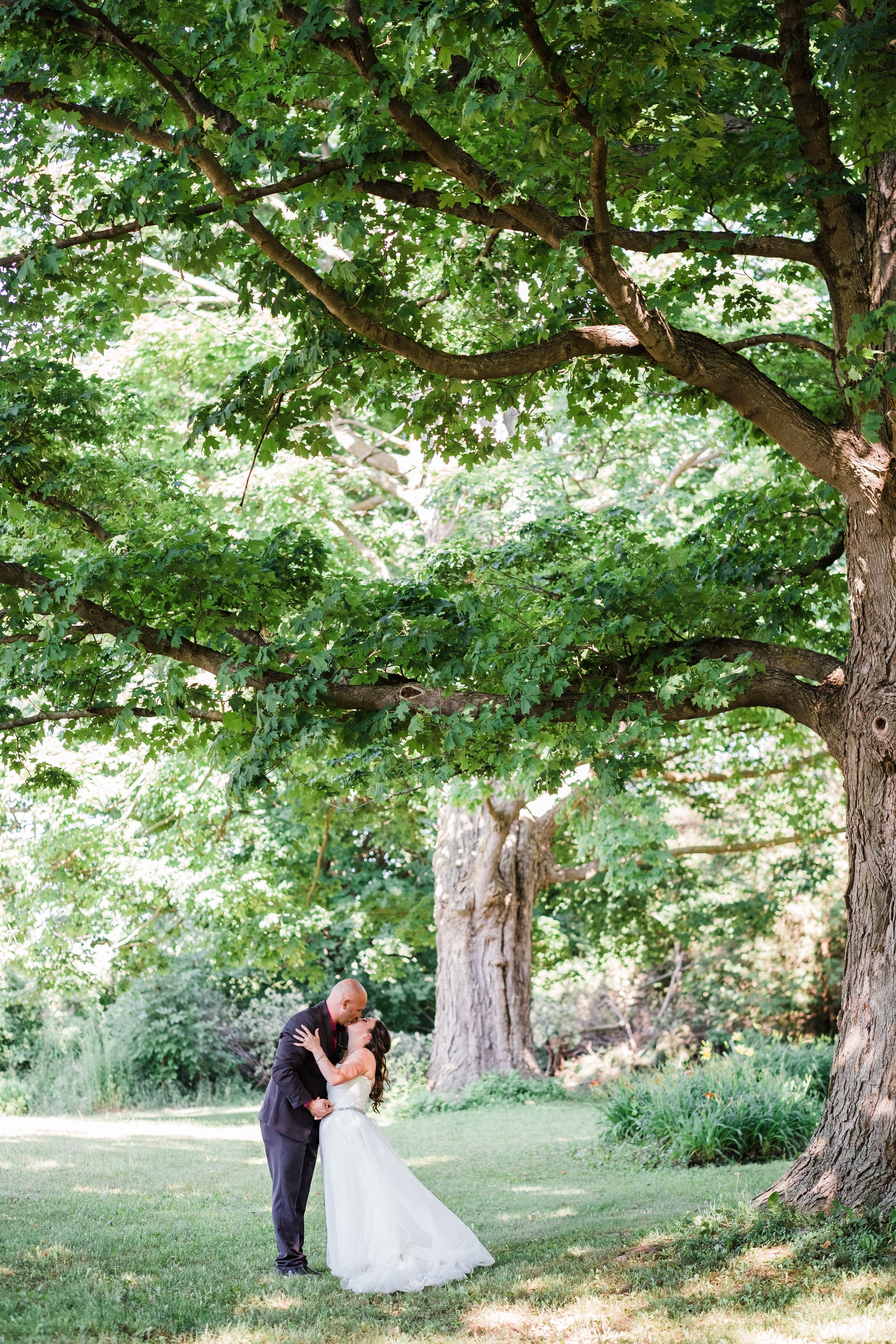 The wedding ring, Waterloo Regional Police Association, BMKH Photography, KW wedding photographer, Waterloo wedding venue, Kitchener wedding venue, Cambridge wedding venue, bride and groom kissing on a path among the trees