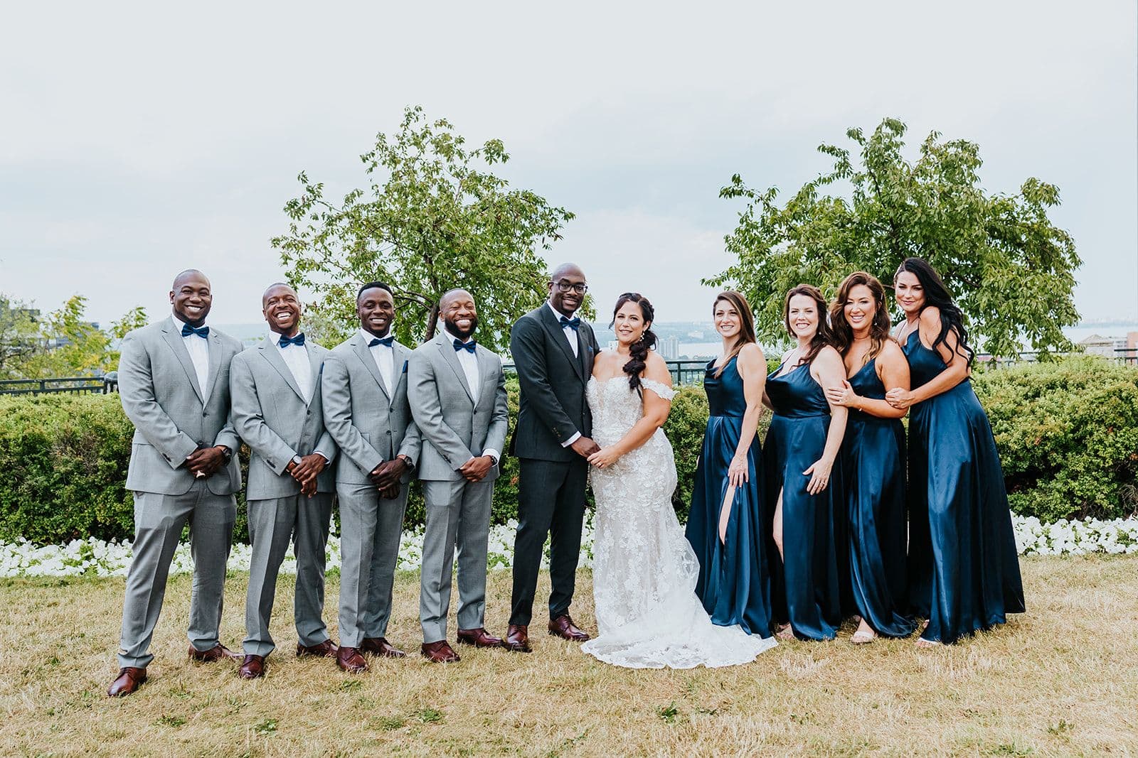 C Hotel by Carmen's, Hamilton wedding venue, Fedora Media, Cambridge wedding photographer, the wedding ring, bride and groom and wedding party standing together with trees in the background