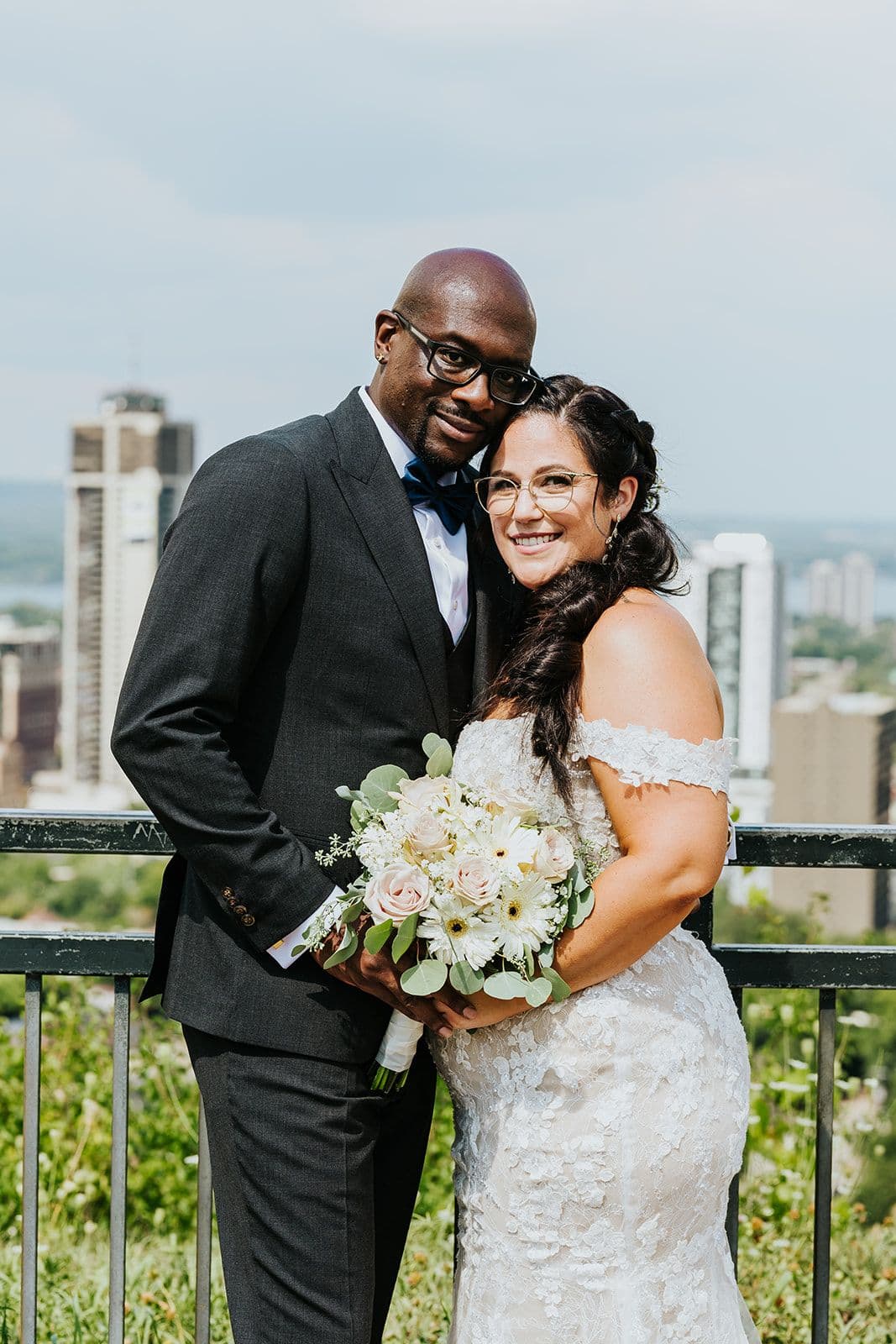 C Hotel by Carmen's, Hamilton wedding venue, Fedora Media, Cambridge wedding photographer, the wedding ring, bride and groom looking at camera with Hamilton skyline in the background