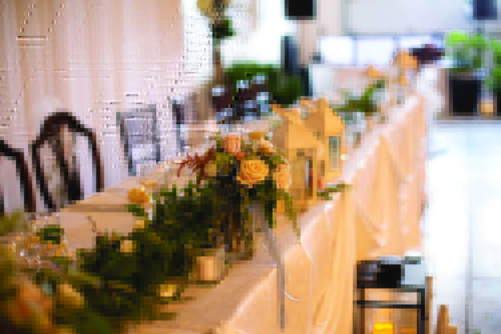 classic neutral wedding decor with long head table and lush florals