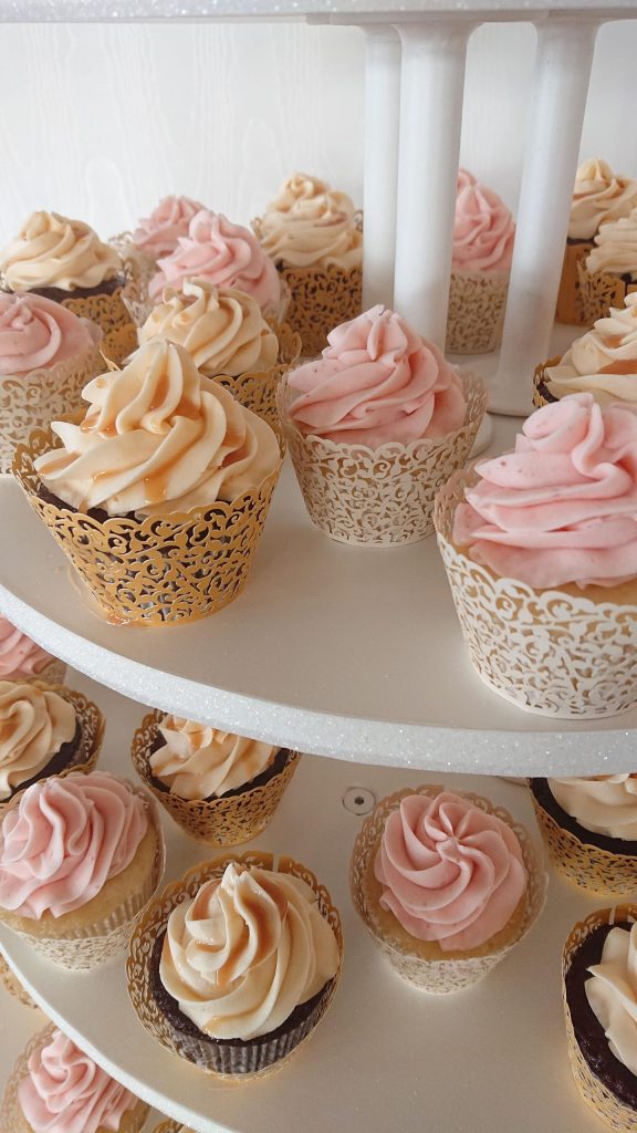 Delicious salted caramel and strawberry lemonade cupcakes complete in beautiful gold and ivory lace wrappers.