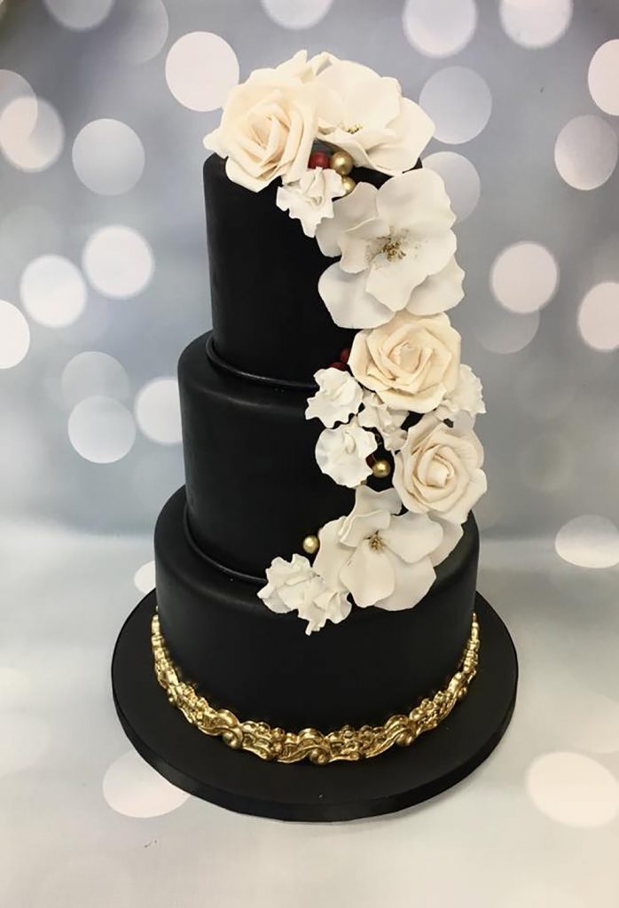 Go bold with an all black cake as the backdrop for stunning white florals.