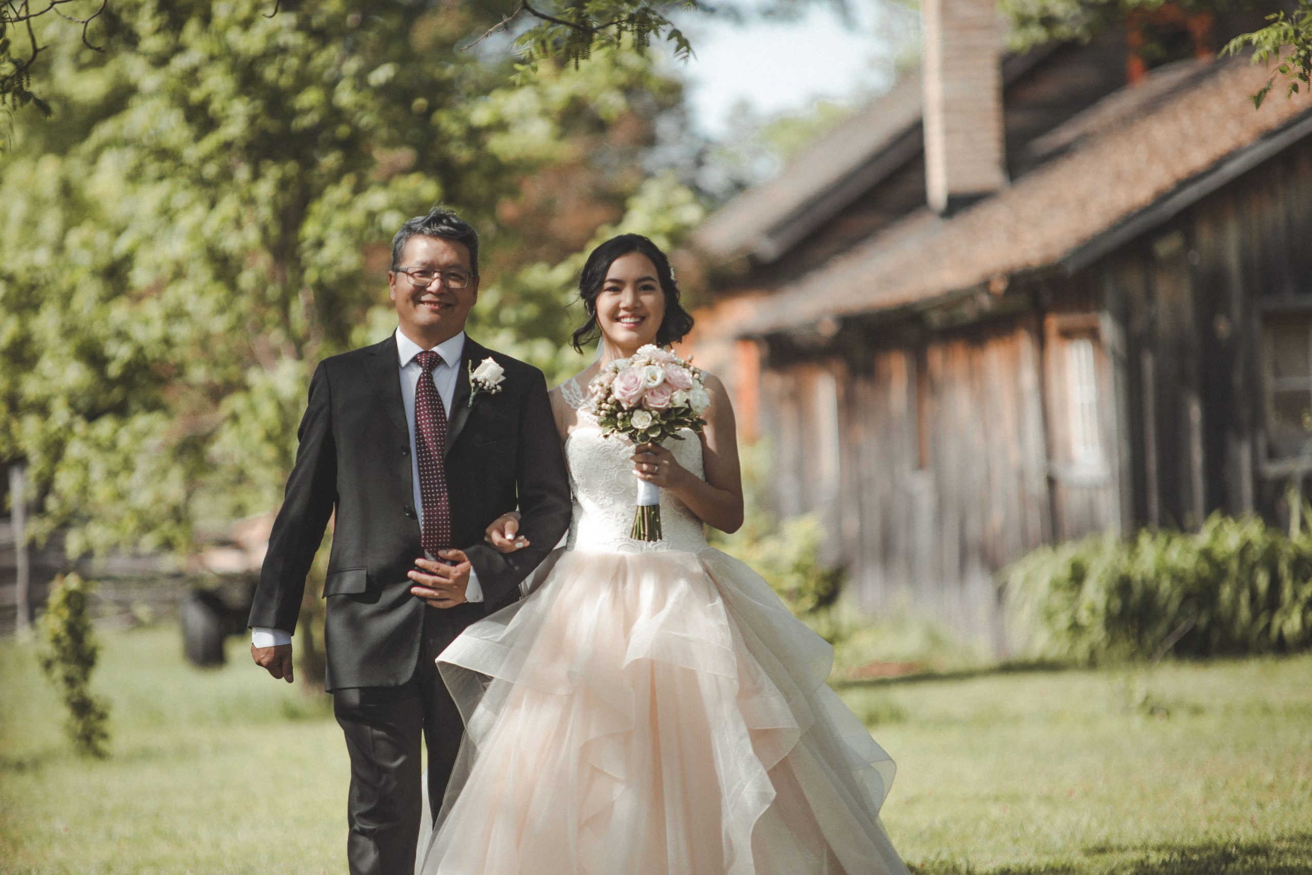 bride and father walk down isle at fanshawe pioneer village