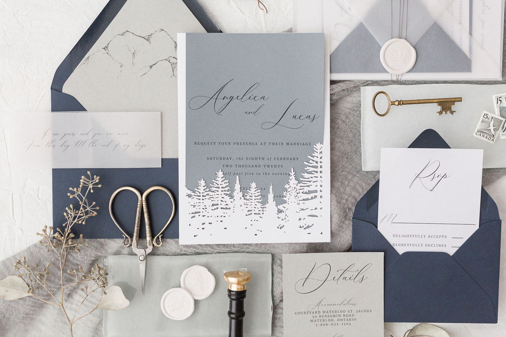 gorgeous blue and grey invitation suite with forest accents
