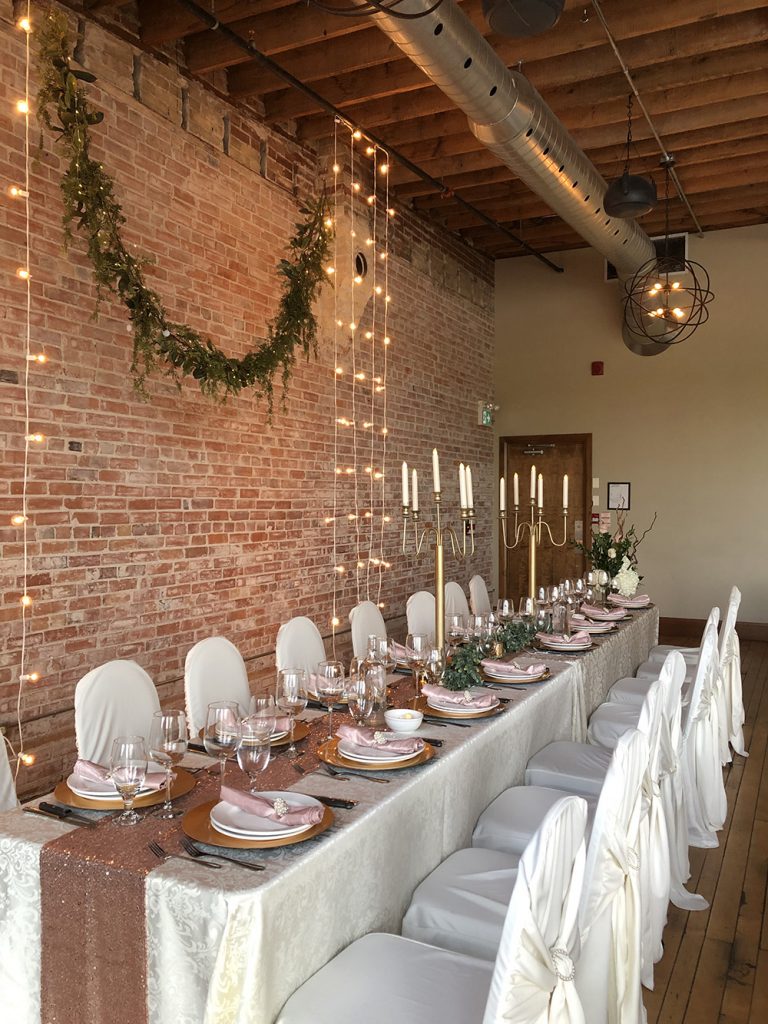 long table wedding decor in rose and brick