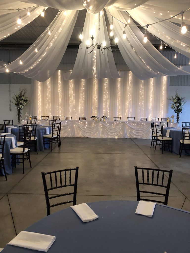 head table wedding decor with lights and ceiling canopy now & always