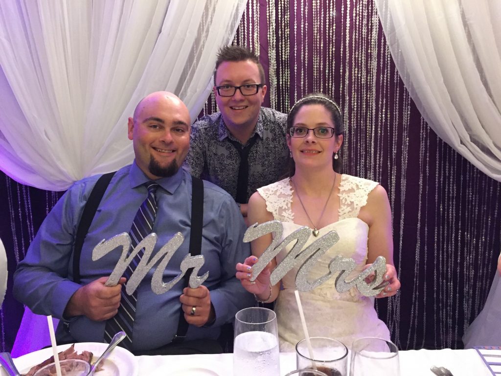 day 2 knight events bride and groom with Mr and Mrs signs
