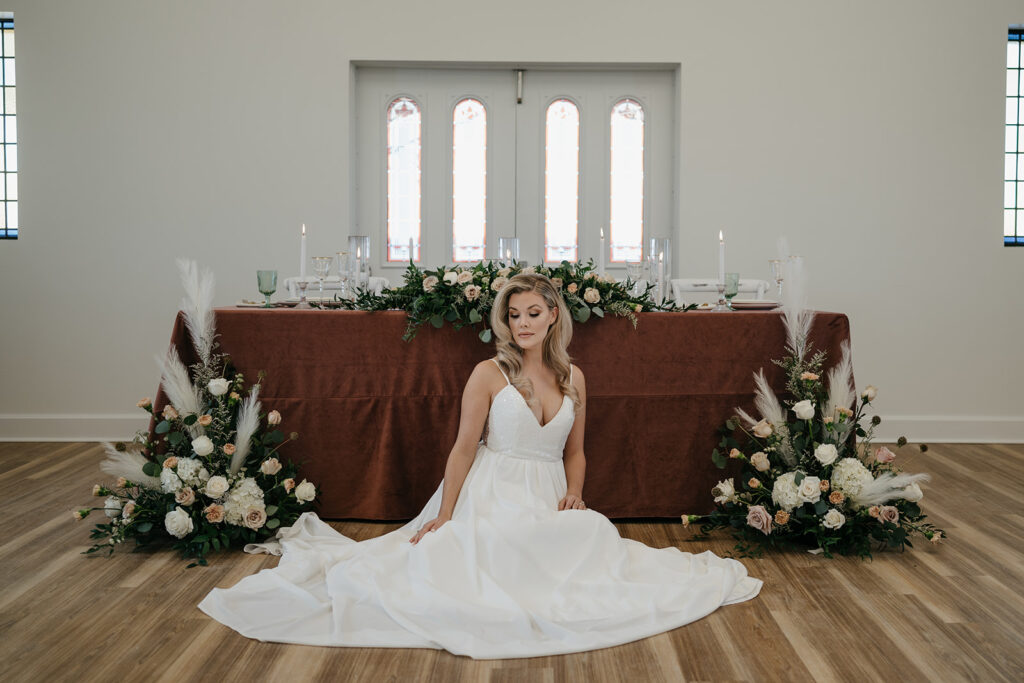 Soft and simplistic, style shoot, bride in white bridal dress in front of head table