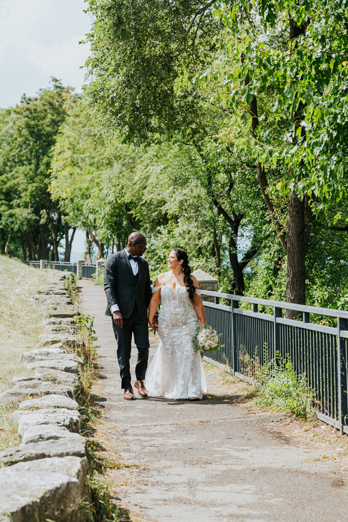 C Hotel by Carmen's, Hamilton wedding venue, Fedora Media, Cambridge wedding photographer, the wedding ring, bride and groom walking down path holding hands and looking at each other