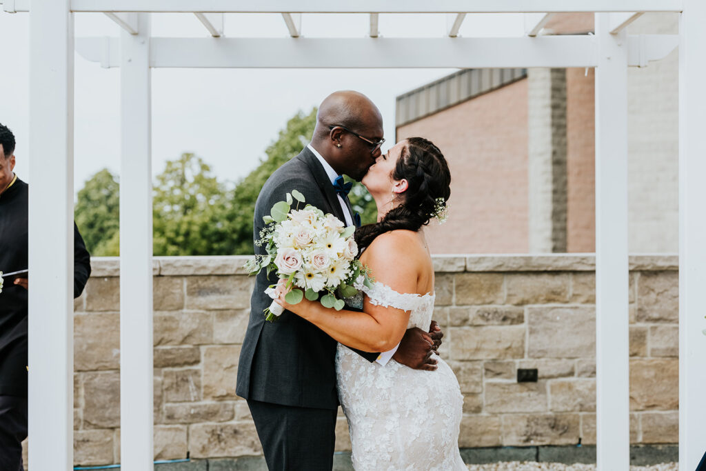 C Hotel by Carmen's, Hamilton wedding venue, Fedora Media, Cambridge wedding photographer, the wedding ring, bride and groom kissing at alter after being pronounced married