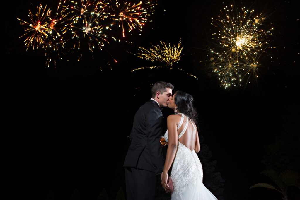 the wedding ring, DA Photography, KW wedding photographer, Edgewater manor, stoney creek wedding venue, bride and groom kissing at night with fireworks in the sky