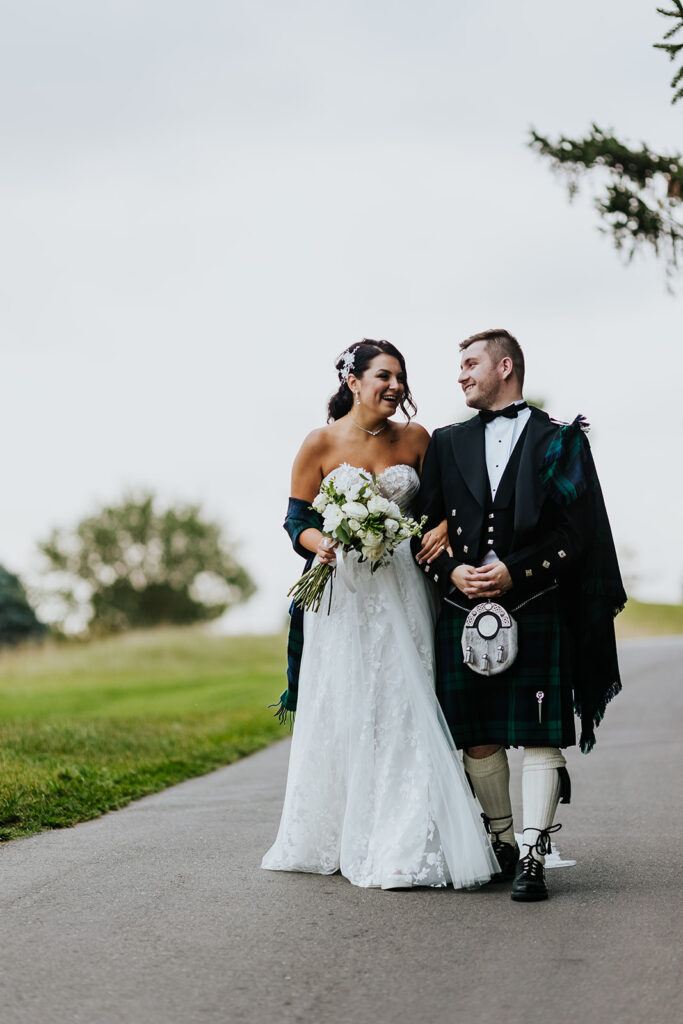 The Wedding Ring, Whistle Bear Golf Club, Wedding Venue, Kitchener Waterloo Wedding Venue, Fedora Media, Kitchener Wedding Photographer, Bride and Groom arm in arm walking down path on golf course